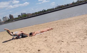 Girl laying out getting sun in a white thong bikini