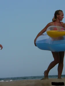 Sexy mom and daughter in red thongs at the beach