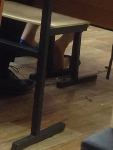 Candid teen shoe dangle in class