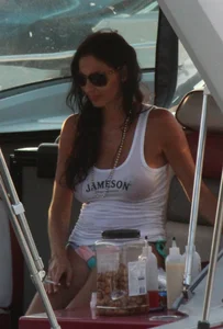 Bikini babe on a boat with a wet see through white shirt showing her tits
