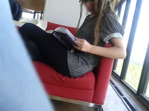 A Skinny Candid Girl in Black Pantyhose And Sneakers Reading on a Library Couch With Crossed Legs Creepshots