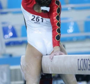 Skinny Teen Athlete Sitting on Gymnastics Bench