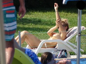 Topless lady at the pool with nice tits