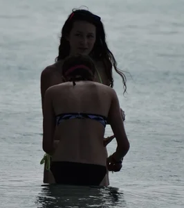 Two candid skinny teen sisters in bikinis