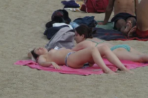 Topless girls on a beach in Barcelona