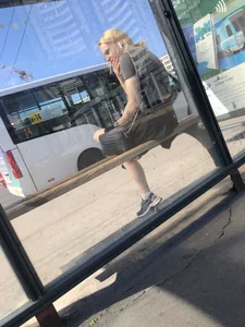 Very cute bespectacled blonde candid teen sitting with crossed legs at the bus stop creepshots