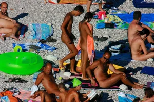 FKK Nudists playing in the water with floater