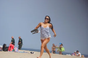 Trio of girls in bikinis on the beach and one with an incredible ass
