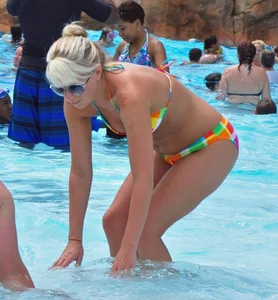 Blonde milf with a sexy body in bikini at the pool