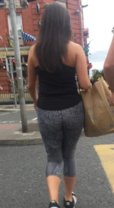 Sexy girl walking in grey patterned leggings with friend in tight jeans