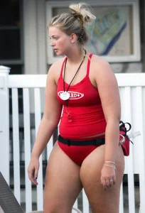 Thick blonde lifeguard in red swimsuit
