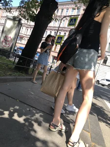 Candid girl in denim fringed shorts waiting on crosswalk, hot long and slim legs creepshots