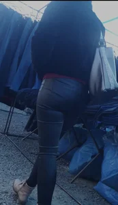 Milf shows off her shapely ass in her leather pants at the market