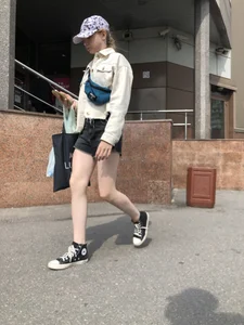 Cute candid teen with pale slim legs in shorts