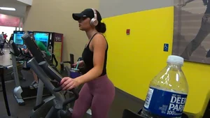 Smoking hot brunette working out at the gym in tight leggings