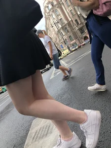 Closeups of a candid girl's legs on a crosswalk