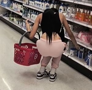 Latina bends over showing thong and chain lace!