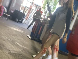 Bunch of girls in various outfits at a Cardinals baseball game