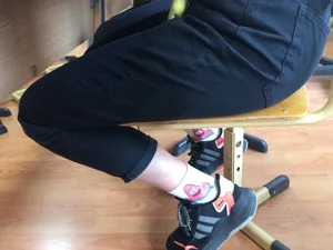 Skinny Teen Girl’s Legs in Black Jeans And Funny Socks Under Desk Creepshot
