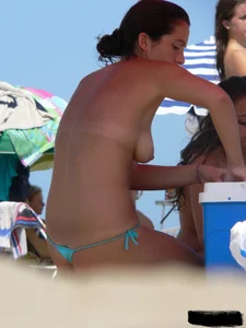 2 topless thonged sexy friends on the beach with great bodies