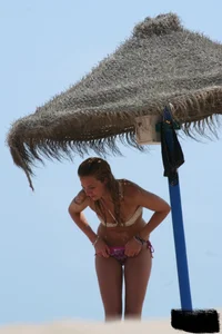 Hot beach girl undressing and going topless