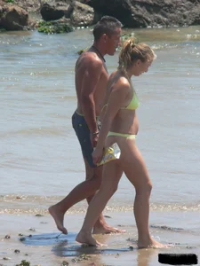 Sexy blonde on the beach in a yellow thong bikini