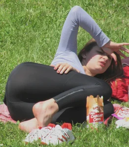Candid girl lying on grass in the park