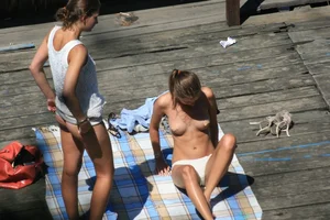 Two teens stripping and going topless to tan
