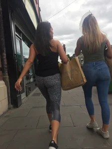 Sexy girl walking in grey patterned leggings with friend in tight jeans