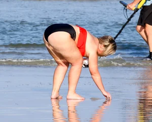 Thick BBW blonde lady in a bikini at the beach