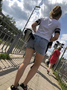 Cute Girl in Denim Shorts Walking Down a Railway Station Gallery