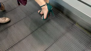 Milf's feet in high heels travelator closeups