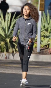 Beautiful black girl in Nike leggings in the parking lot