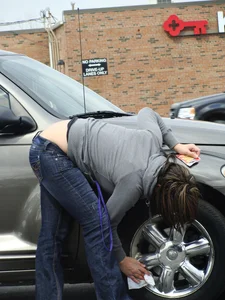 Girl cleaning her car in jeans and showing some cheetah print underwear