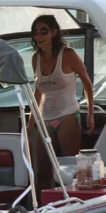 Bikini babe on a boat with a wet see through white shirt showing her tits