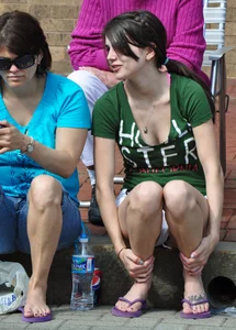 Cute brunette sitting in white shorts and showing a little cleavage