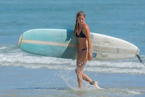 Candid girls surfing on the beach