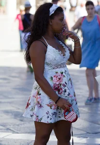 Black girl showing major cleavage in dress and almost upskirted