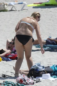 Big boobed thick blonde on the beach in a bikini
