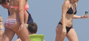 Two thick white girls in bikinis on the beach with big asses