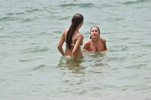 Two sexy ass girls on the beach in bikinis