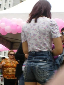 Redhead girl with her cheeks eating her denim shorts