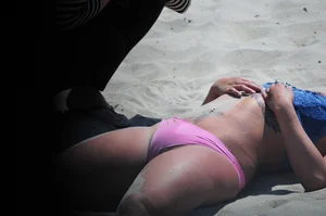 Tattooed Milf in Swimsuit Lying on the Sand with Her Feet Up Beach Creepshots Gallery