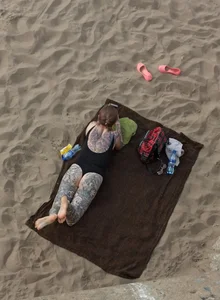 Chubby Girl in Body Swimsuit Covered With Tattoos Lying on the Beach