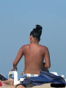 Hot ass topless beach girl with great tits lets her little brother oil up her ass in thong bikini