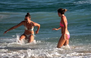 Sexy beach girl in bikini with her other sexy friend