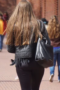 Pretty girl walking in tight black pants