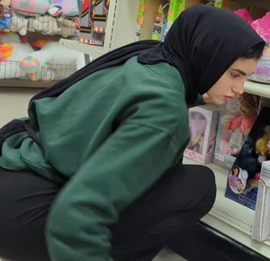 Hijab Princess stocking shelves @ department store