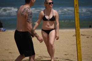 Chunky blonde in a black bikini on the beach