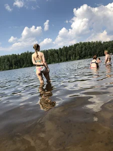 Cute Girl in Swimsuit Standing in Water and Lying on a Beach Gallery